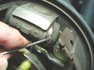 When inspecting a brake drum, always inspect the wheel cylinder for leakage by prying away the rubber end cap. Because they can't be successfully honed, aluminum wheel cylinders should be replaced.