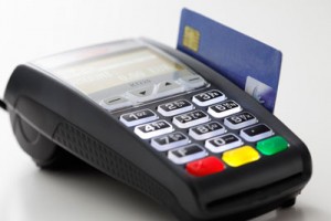 EMV terminals, like this Ingenico iCT 220, prompts customers to insert their card (chip facing upward) into a slot in the terminal,, which is often located below the keypad. 