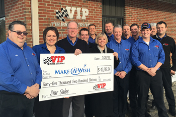President Nancy Koglmeier (right) accepting the $45,216 check on behalf of Make-A-Wish from VIP CEO John Quirk (center), VIP office manager Mary Daigle (left) and members of the VIP store support team on Jan. 26, at the company’s Lewiston headquarters. 