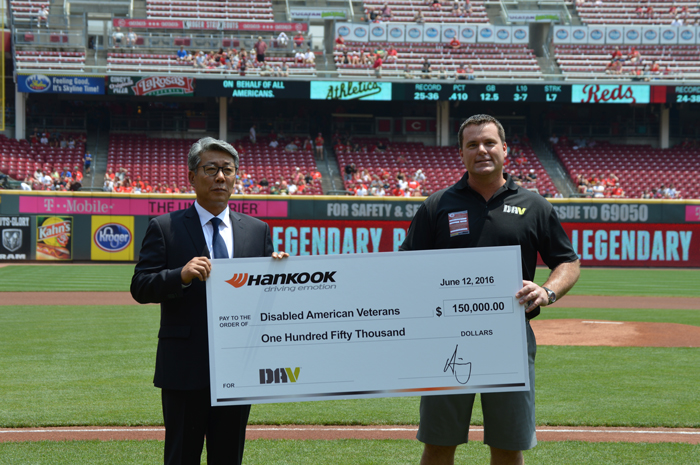 Hankook Tire America Corp. president Hee-Se Ahn presents DAV executive director Barry Jesinoski with a $150,000 check.