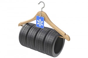 Winter car tyre on wooden hanger