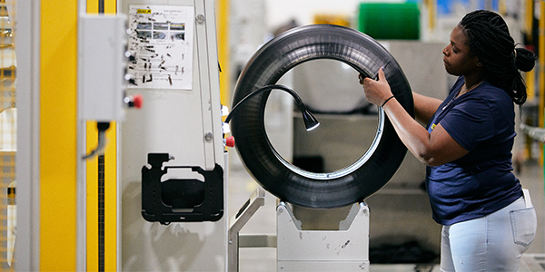 A Giti Tire USA employee inspects a tire for any abnormalities.