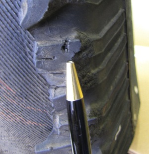 A photo of the damaged tire shows a 1/8-inch puncture well into the shoulder area.