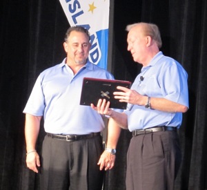 Dan Brown, president of Tire Pros for ATD, recognized Tom Ceniglis for his service as chairman of the Tire Pros National Dealer Council.