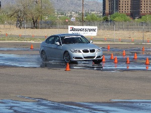 Dealers and media tested the all-season UHP Potenza RE970AS Pole Position on a wet handling course at Firebird International Raceway.
