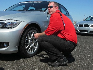 To demonstrate the third-generation run-flat technology in the new Potenza RE960AS Pole Position RFT, Bridgestone allowed participants to drive the course with one tire underinflated. Douglas Grass, field engineer for Bridgestone Americas, deflates the tire.