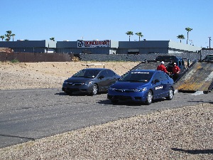 Two 2011 Honda Civics - one fitted with Ecopia EP422 tires (right) and one with Bridgestone Turanza EL 400 tires - were used for a rolling resistance demonstration.