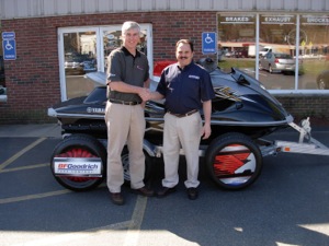 bob vacca of summit tire northeast/terry's tire town (left) presents a personal watercraft to kevin conley of long distance tire in medway, mass.