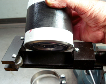 Oil filter cutters are handy for detecting metallic debris trapped in the oil filtering media. The duct tape helps the filter wrench grip the filter canister.