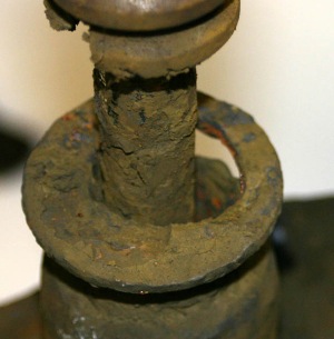 this rear strut shows the ultimate result of neglect and/or lack of inspection. the seal and upper part of the tube are completely gone. the housing has been distorted by braking forces. the driver thought she had brake problems and did not notice the changes in vehicle behavior over the period of time it took the strut to degrade.