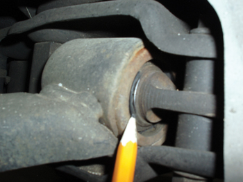 Photo 9: The bright metallic spot on the control arm shaft indicates metal-to-metal contact. 