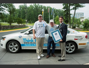 From left: Bob Winger; president and CEO of Volkswagen Group of America Jon Browning; and Wayne Gerdes are pictured following a Guinness World Record certificate presentation at Volkswagen Group of Americas headquarters in Herndon, Va.