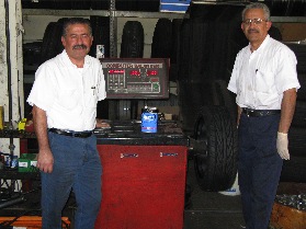 Jim and Abe Torro, co-owners of Orange Auto Center in Orange, Calif., with their ancient Coats balancer.
