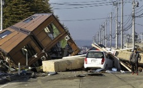 A collapsed house and debris at Sendai Port in Sendai, northeastern Japan, on March 12. (AP Photo/Koji Sasahara)