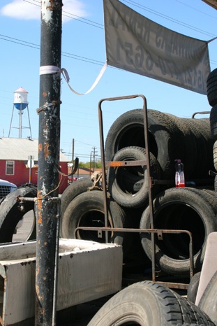 Ricks Tires is an eyesore, according to the city of Kyle, which has given the local business 30 days to erect a fence or move the piles. (Photo-Hays Free-Press)