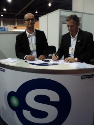 Fabien Bouquet, point S international operations director (left) signed an agreement with IDTG Michael Cox, president and CEO, this week at the SEMA Show/Global Tire Expo.