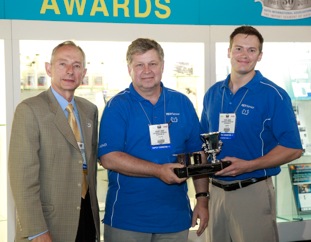 (From left) Stephen Bearden, AIA chairman, presents the award to Helmut Ernst and Steve Landis of Continental Corp.