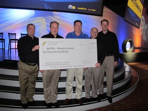 Olson Tire & Auto Service chief Kent Olson (middle) receives $10,000 donation check earlier this week at the Goodyear Dealer Conference in Orlando from (L to R) Jack Winterton, president of Goodyear North American Tire units consumer business unit; Steve McClellan, president of Goodyear North American Tire; Todd Pickens, Goodyears senior director of consumer sales; and Ryan Patterson, vice president of consumer operations and customer development